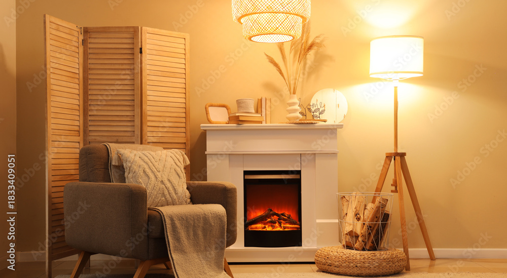 Fototapeta premium Interior of cozy living room with fireplace, armchair and glowing lamps