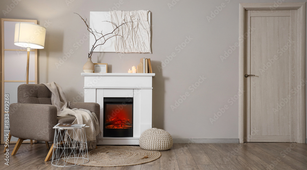 Fototapeta premium Interior of living room with fireplace, armchair and glowing lamp