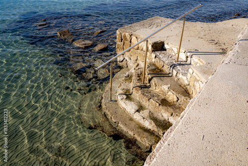 Fototapeta Naklejka Na Ścianę i Meble -  stone steps in a park by the sea, island of Rab, Croatia, Mediterranean, clear, blue sky