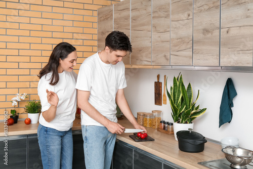 Happy young couple cutting ...