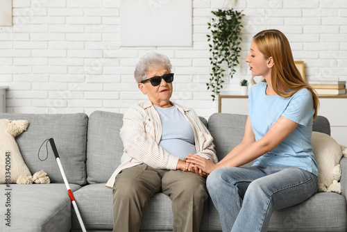 Young woman with blind gran...