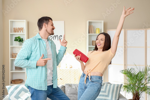 Young couple with portable ...