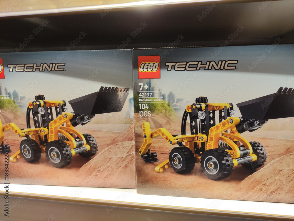 Fototapeta premium Rome, Italy - November 29, 2025: LEGO Technic construction vehicle set displayed on shelf, featuring detailed design and vibrant colors, ideal for creative building and playtime fun