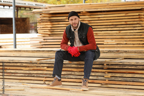 Male carpenter sitting on w...