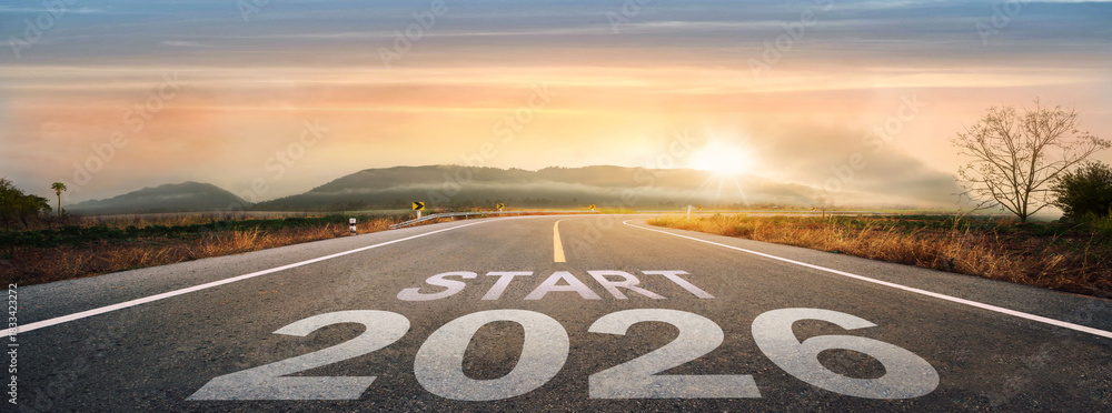 Fototapeta premium Start 2026 written on highway road in the middle of empty asphalt road of asphalt road at sunset.