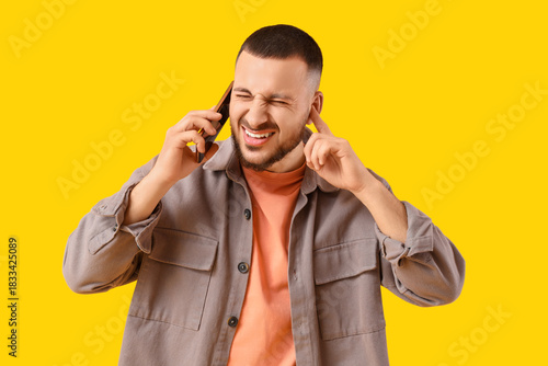Young man with mobile phone...