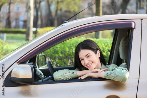Happy young woman sitting i...