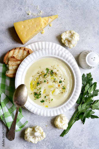 Vegetarian cauliflower cream soup with croutons  in a bowl. Top view with copy space.