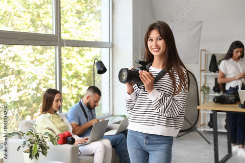 Female photographer with camera during courses in studio