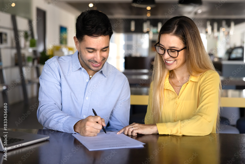 Fototapeta premium Positive business expert woman pointing at place for signature
