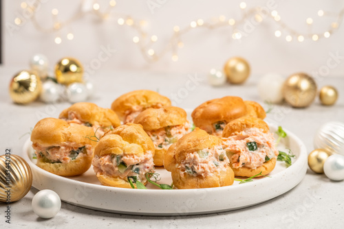 Smoked Salmon Cream Puffs served on a round plate with festive decorations