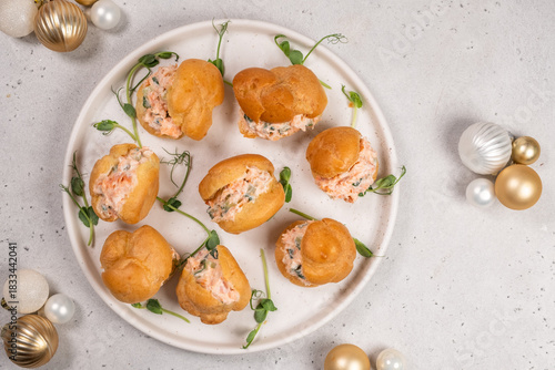 Smoked Salmon Cream Puffs served on a round plate with festive decorations