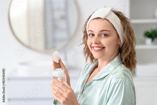 Young woman with bottle of ...