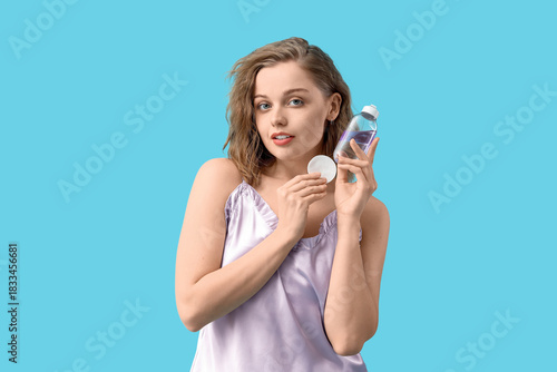 Young woman with bottle of ...