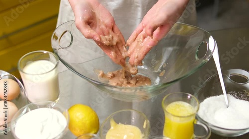 Mixing eggs with milk whisking dough in a glass bowl. mix fresh yeast with sugar by hand