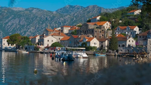 Montenegro, Kotor, June 23, 2025. Perast village docked boats reflecting on bay of kotor water. Charming perast village in montenegro with stone houses reflecting on the calm water of the bay of kotor