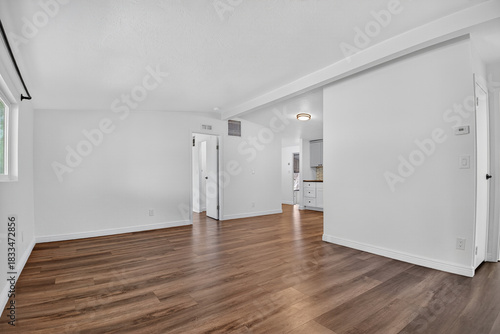 Generous Living Area Adorned With Timber Surfaces And Extensive Window Openings Suitable For Remodeling