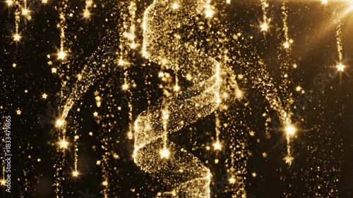 Abstract golden streamer and sparkling particles against dark background
