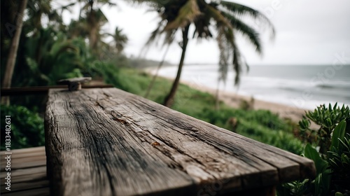 Weathered Wooden Table Near Beach with Palm Trees and Ocean View in Tropical Setting