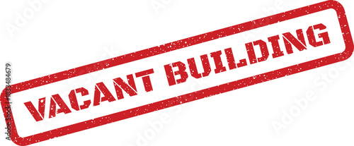 Red textured rectangular rubber stamp impression displaying the bold capital text VACANT BUILDING for property or urban development