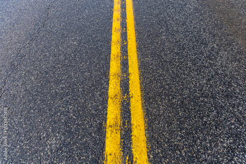 Double Yellow Centerline On Wet Asphalt Road In BC, Canada