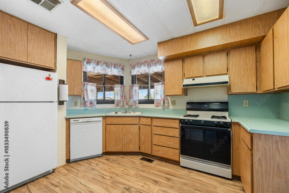 Fototapeta premium A beautifully designed kitchen with wooden cabinets and a white fridge