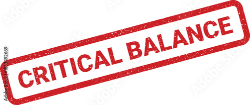 Critical balance text displayed on a weathered red rubber stamp for financial warning notifications
