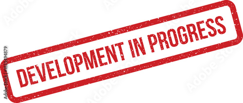 Distressed red rectangular stamp showing Development In Progress text for ongoing project updates