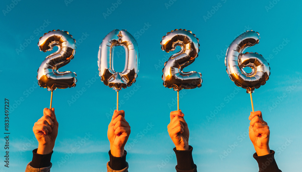 Fototapeta premium Hands holding up silver foil balloons spelling out 