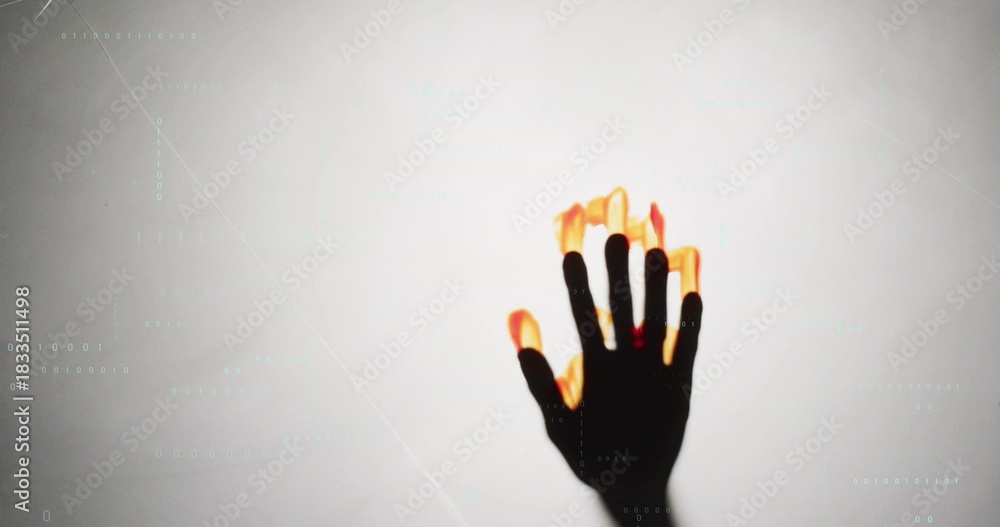 Naklejka premium Reaching dark hand showing glowing flame fingertips at studio backdrop, cyan code lines, copy space