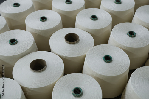 A close-up of a spool of yarn inside the factory