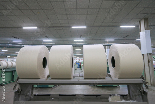 A close-up of a spool of yarn inside the factory