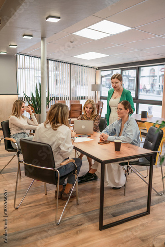 Women meeting teamwork collaborating business professionals discussing strategy in modern office space