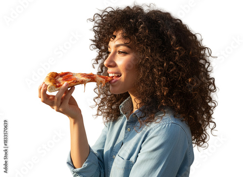 Curly-Haired Woman Holding Pizza Slice Near Mouth, Playful Side Angle Pose Light Blue Shirt