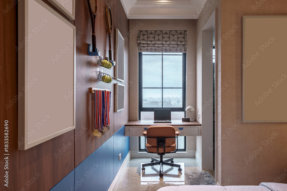 Fototapeta premium Modern study nook area featuring tennis themed decor, medals, window, and a laptop on the desk.