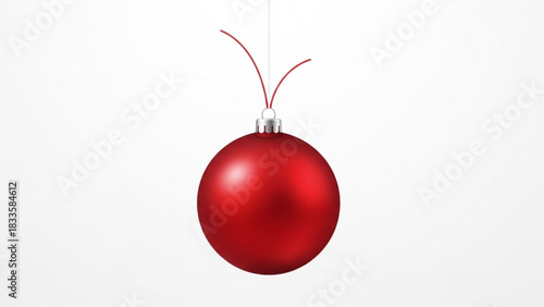 A single shiny red christmas ornament hangs suspended against a clean white background ready for holiday decoration