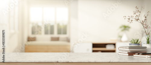 Fototapeta Naklejka Na Ścianę i Meble -  Books and plant aside flower vase on marble counter table with sofa and window in bright living room