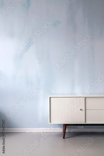 Minimalist Light Blue Wall With White Mid-Century Sideboard In Empty Room