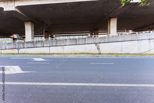 Concrete structure and asphalt road space under the overpass in the city