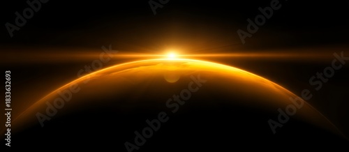 Bright golden sunrise or sunset glows over the curve of a planet with lens flare in deep space