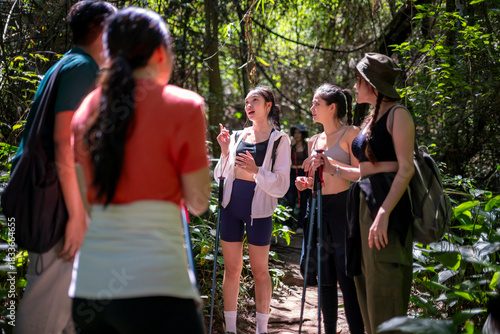 Group of asian hikers listening to tour guide in forest
