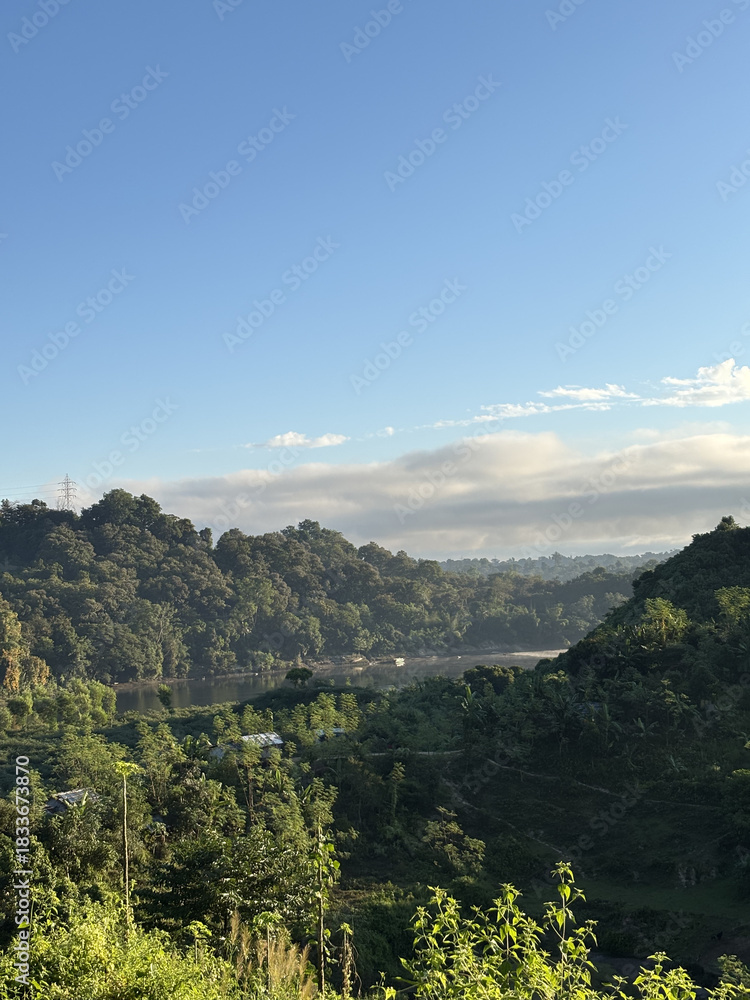Naklejka premium Morning mountain and sea landscape with forested hills and clouds