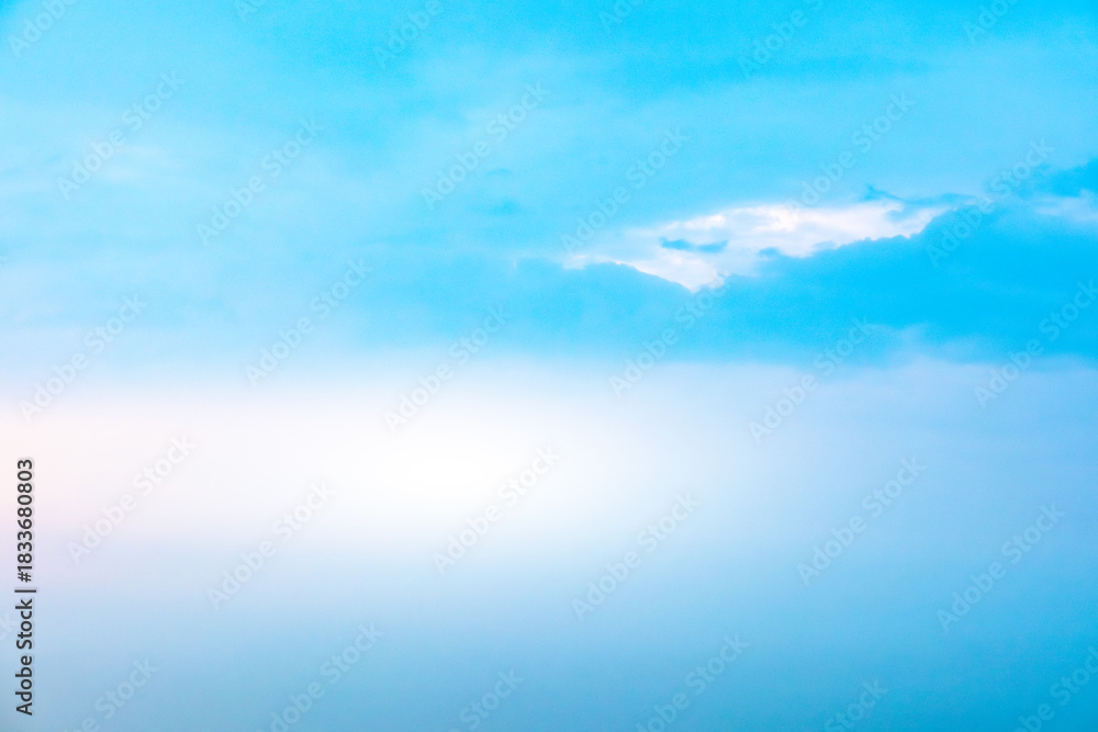 Obraz premium A bright, clear blue sky meets a glowing white horizon, suggesting a serene, open, and with sunlight of beautiful cloudy sky. landscape or abstract background. 