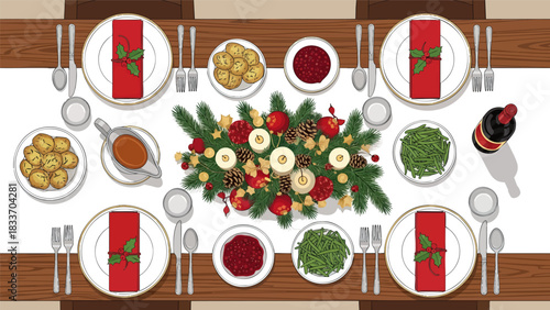 Overhead view of a festive holiday table setting with plates, napkins, silverware, gravy, wine, and a centerpiece of greenery, candles, and ornaments.