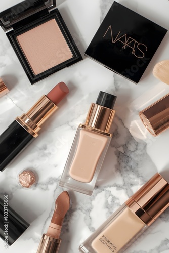 Elegant flatlay of modern neutral cosmetic essentials including foundation, powder, and lipstick arranged on marble surface creating a refined luxury beauty aesthetic