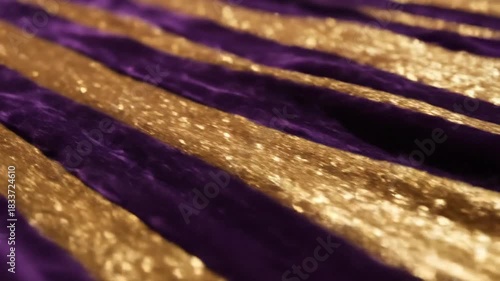 Abstract texture of golden glitter and purple velvet fabric in diagonal stripes for background