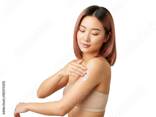 Young asian woman applying moisturizing cream to her arm for skincare.