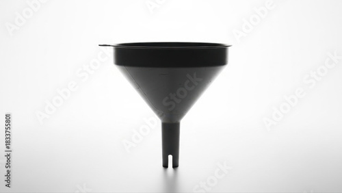 Black funnel used for liquid transfer isolated on a white background, showcasing its simple design and functionality with subtle shadows and clean lines