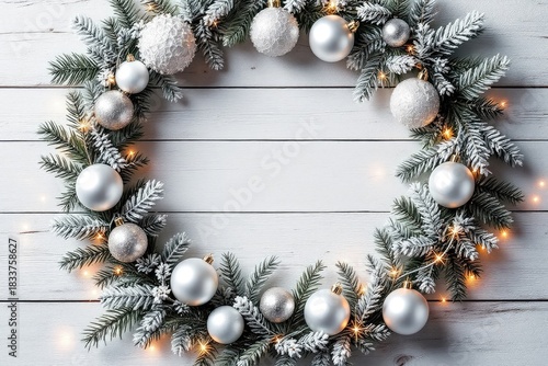 Festive wreath on white wood background