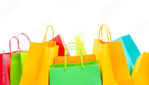Colorful shopping bags arranged in a vibrant display against a white background